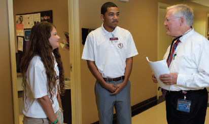 an image of two RMS students speaking with a physician.